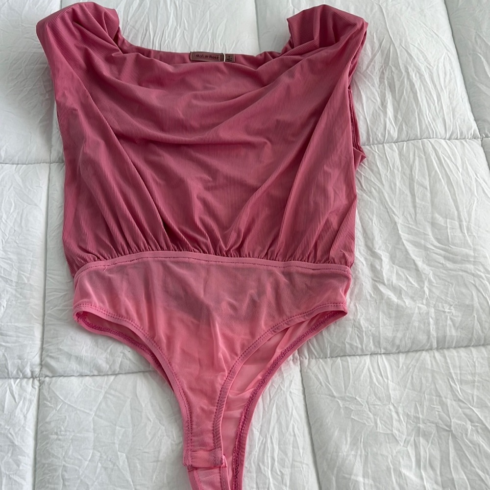 pink body suit with shoulder pads